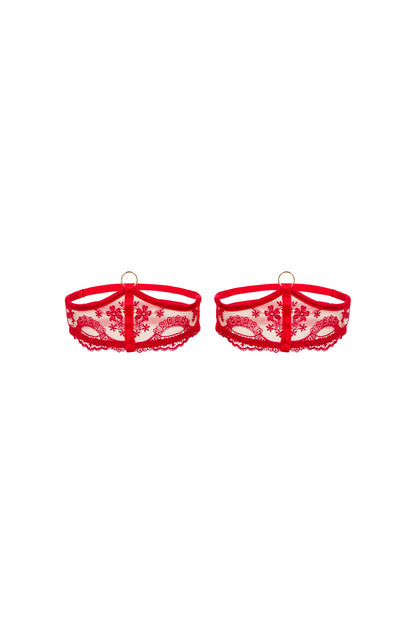 Juliette red thigh garters with scarlet Swiss embroidery, straps and gold O-ring detail on a white background.
