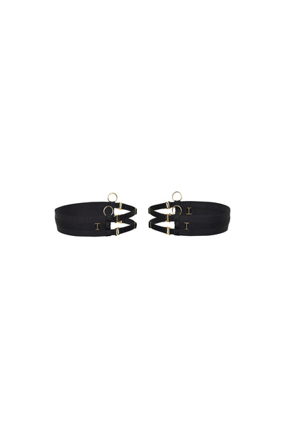 Back view of the Kate black thigh garters with wide bands, adjustable slim straps and gold-tone hardware on a white background.