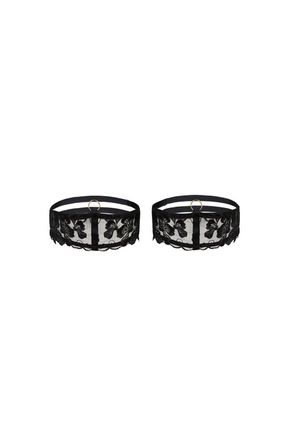 Valerie black thigh garters with Swiss embroidery over sheer tulle, adjustable straps and gold-tone hardware on a white background.